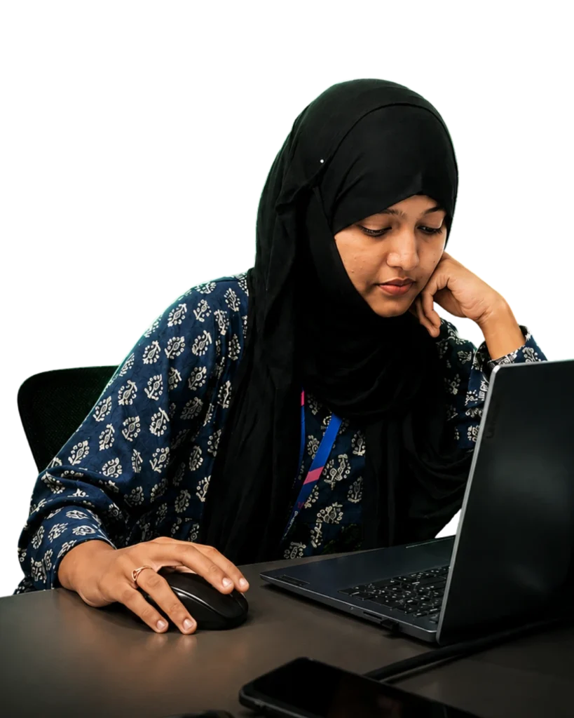 A focused, seated working posture with eyes on the laptop, one hand on the mouse, and the other resting on the chin—representing professionalism, creativity, and a commitment to delivering quality digital marketing solutions.